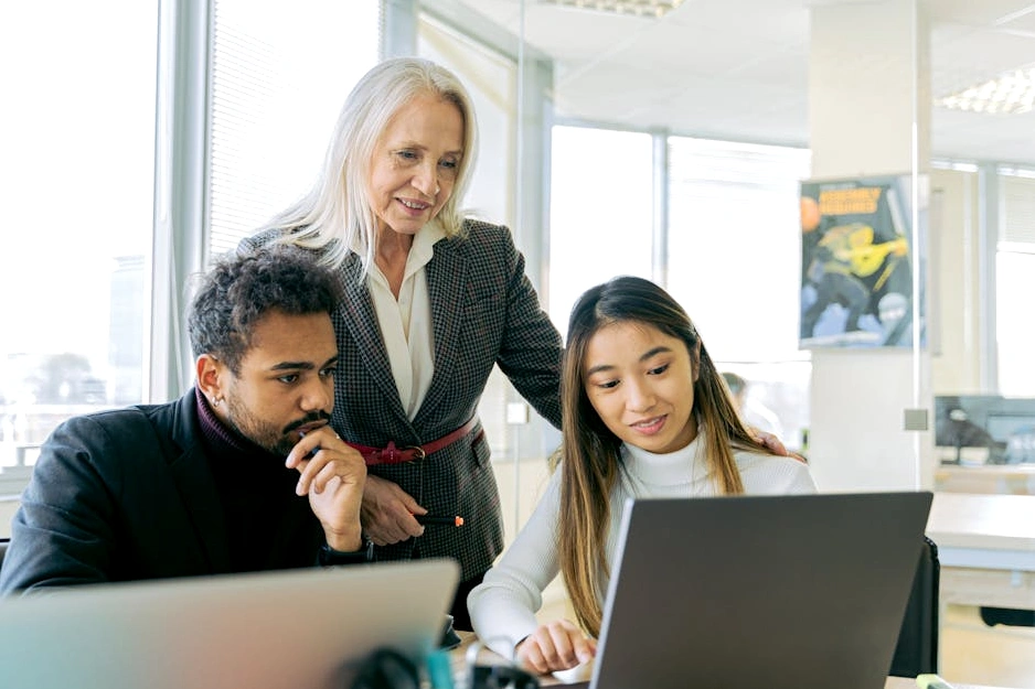 A diverse group of technology consultants brainstorming in a modern, collaborative workspace.